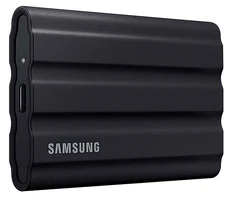 The black Samsung T7 Shield portable SSD, with a ridged rubber shell and a USB-C port on one end.